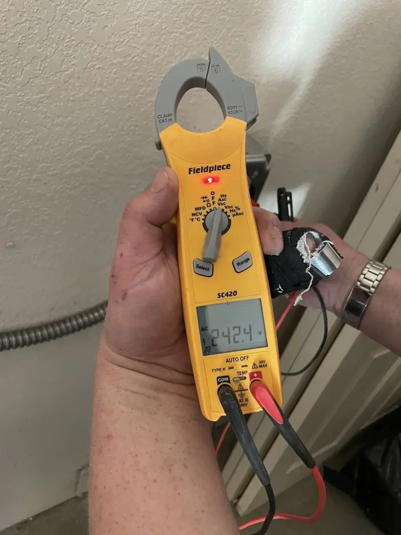 Voltage testing with clamp meter during Outlet Installation in Gifford